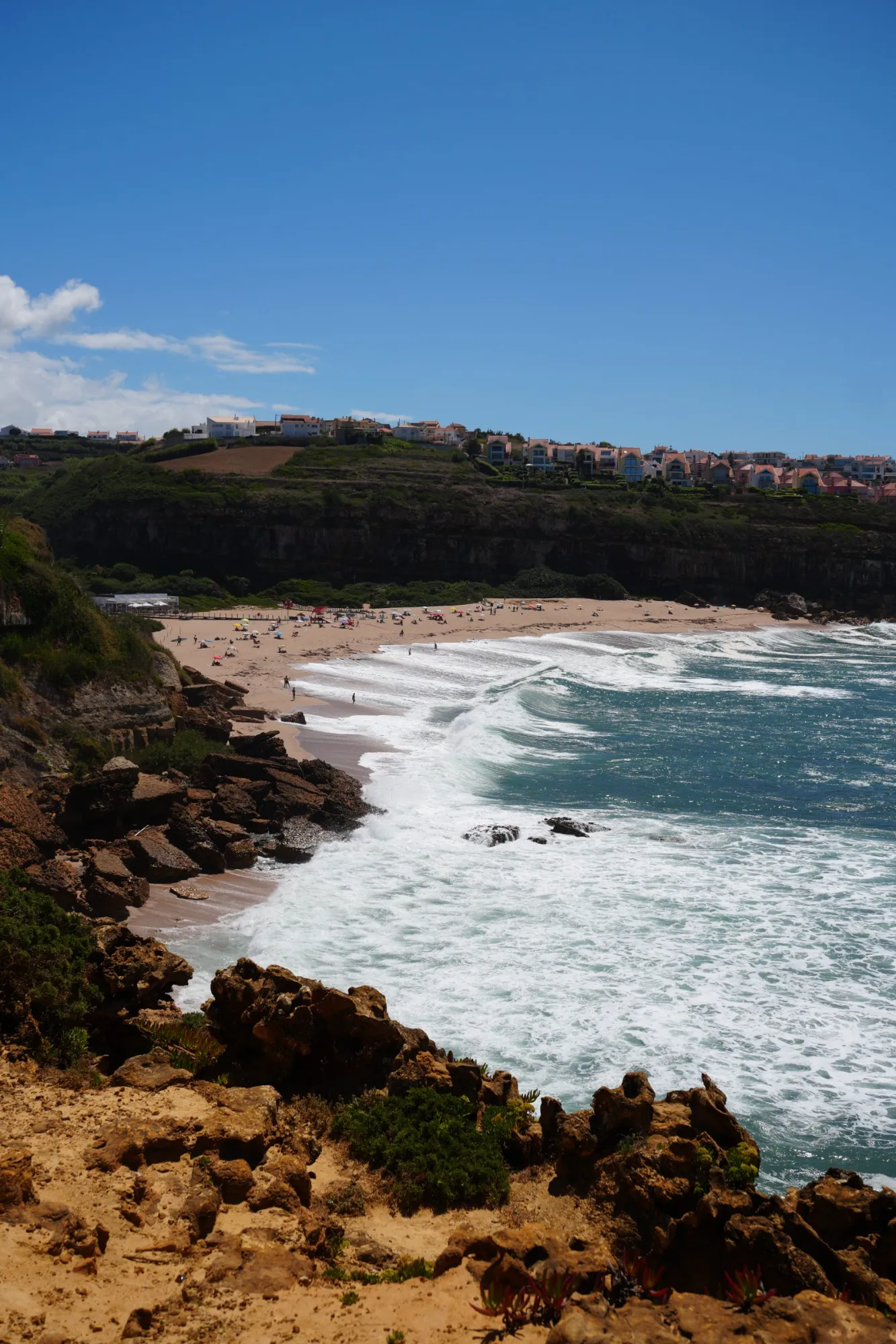 A sheltered sandy cove below cliffs on the Portuguese Atlantic coast