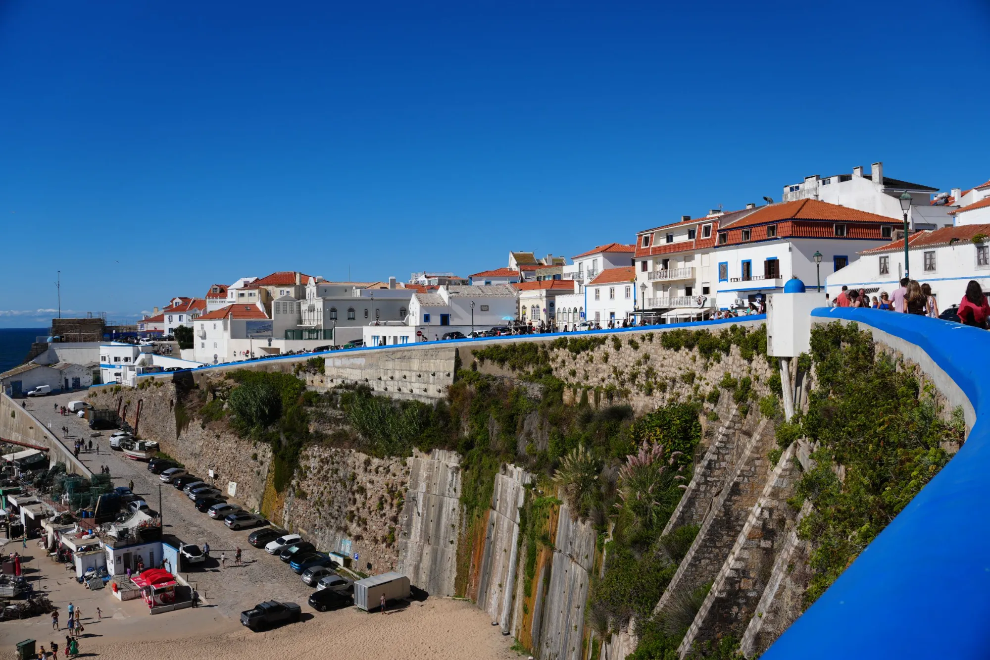 Whitewashed houses above the harbour in a Portuguese coastal village